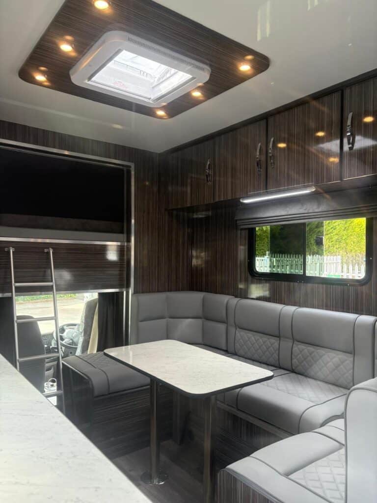 Interior of Millring Horsebox living accomodation showing inbuilt table & seating area.